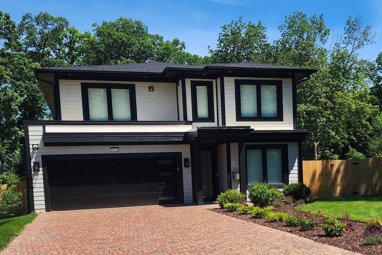 A newly built modern home on a summer afternoon